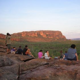 Visitors sitting at Nawurlandja looking out over the escarpment