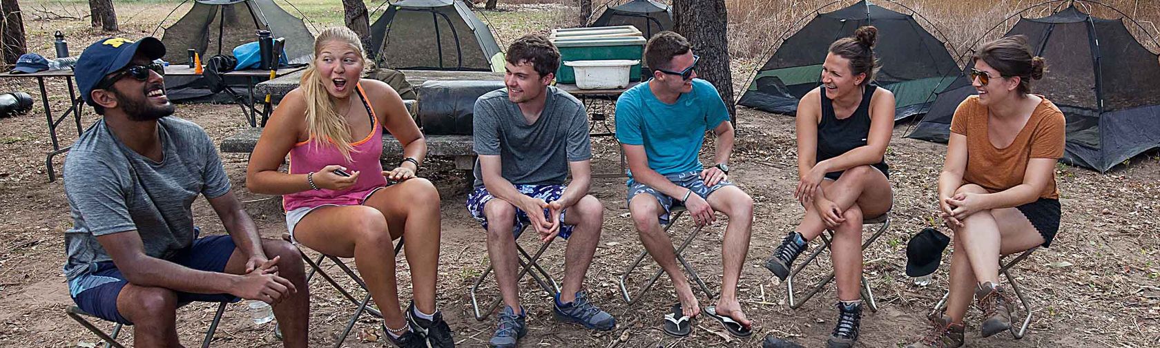 Campers sitting around the campsite. Photo: Territory Expeditions